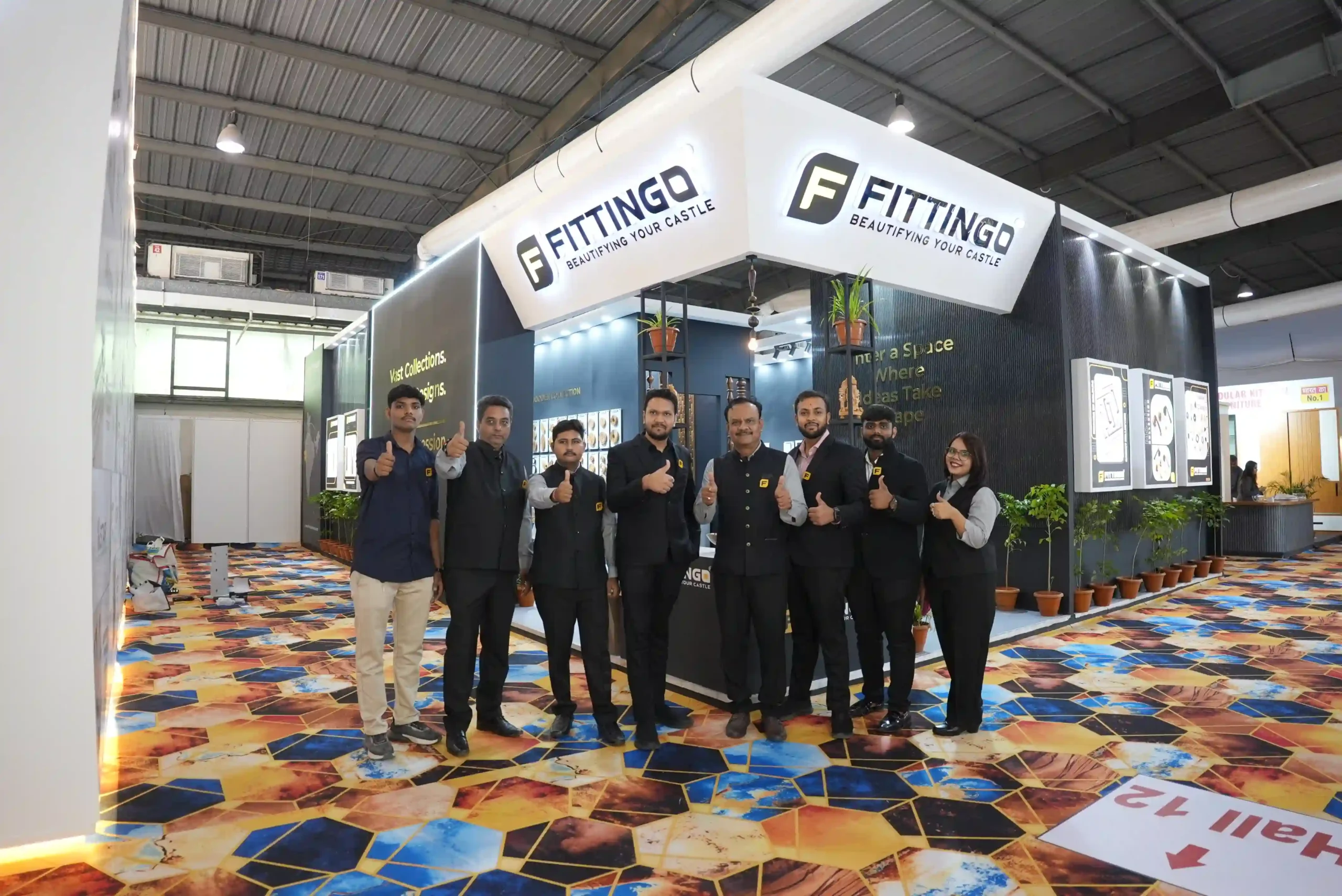 The Fittingo team standing together in front of the stand at the close of the show