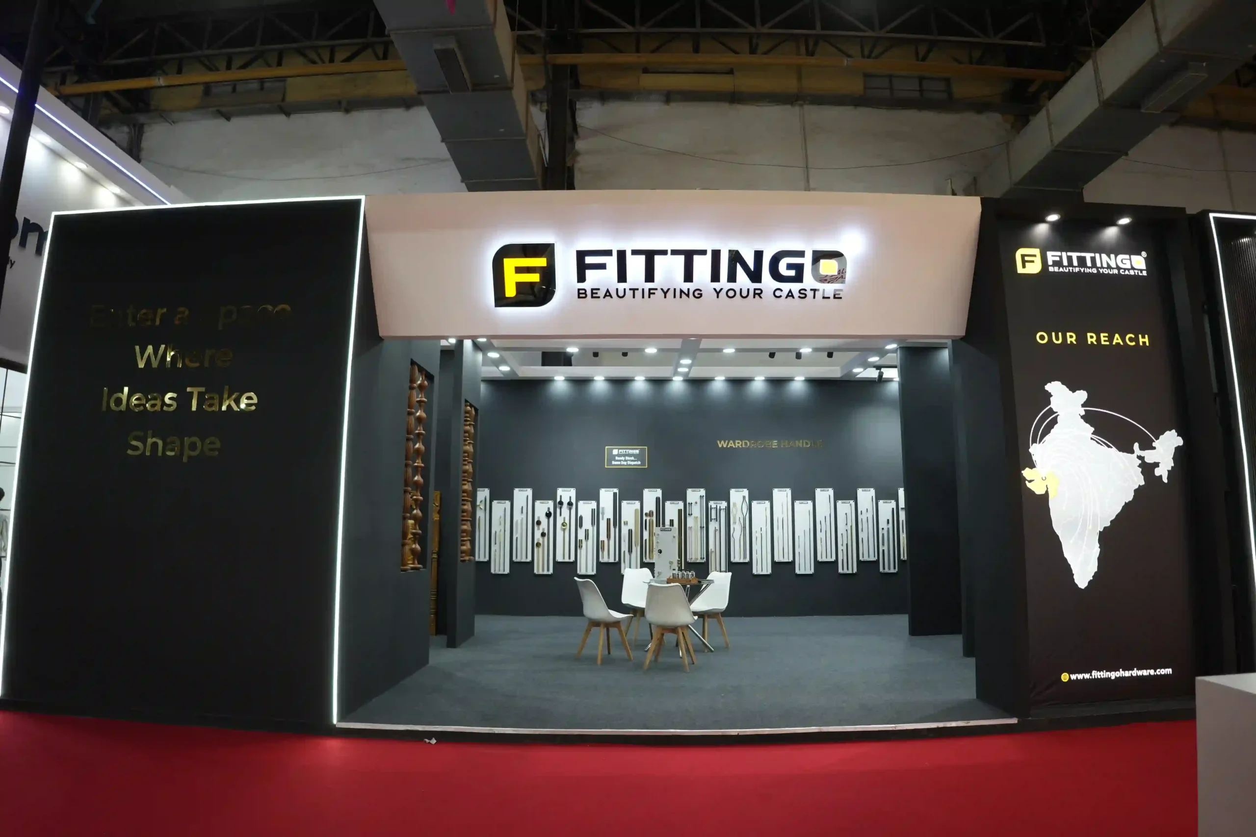 Front elevation of the Fittingo exhibition stand, illuminated signage above a wardrobe handle display wall