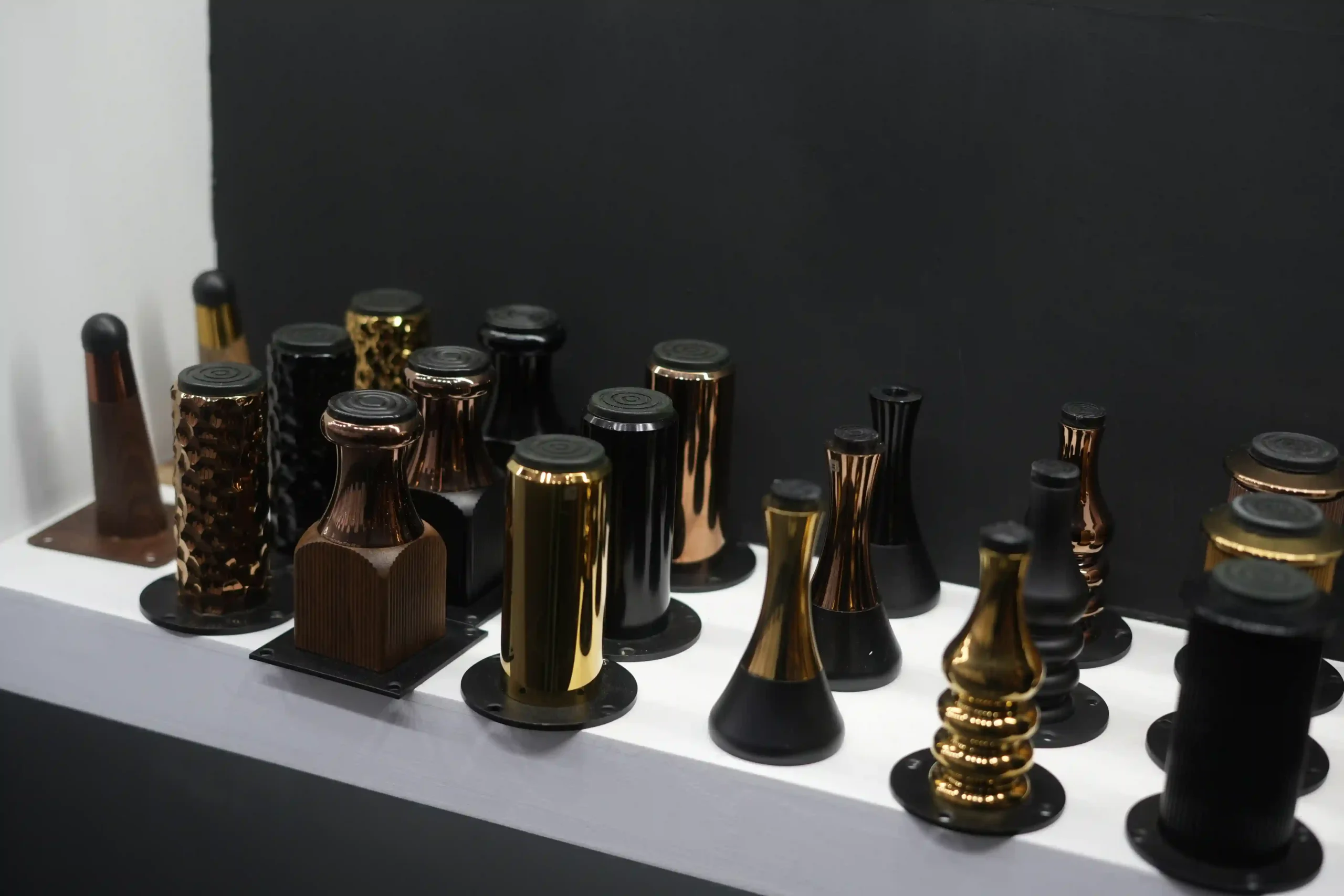 Shelf of PVD coated furniture legs in copper, gold, gloss black and bronze