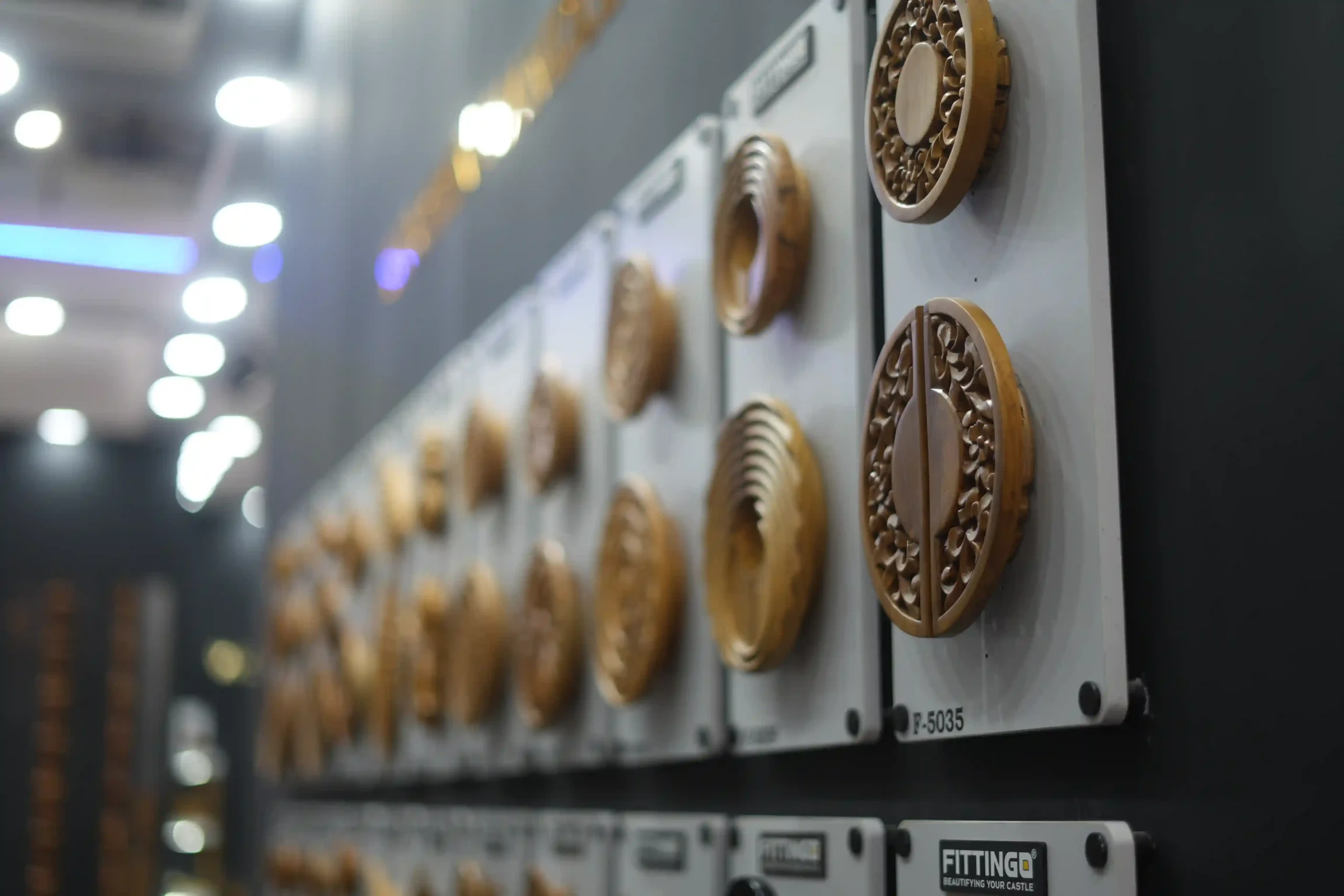 wall of hand-carved circular wooden rosettes mounted on Fittingo display plaques