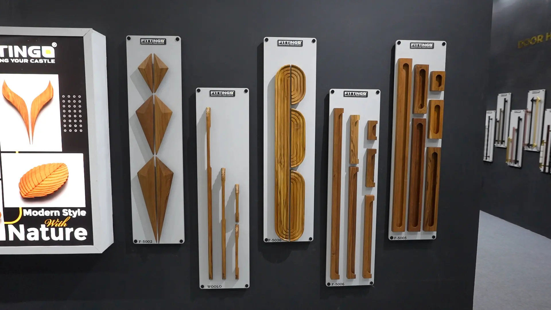 row of turned wooden furniture legs on an illuminated white display shelf